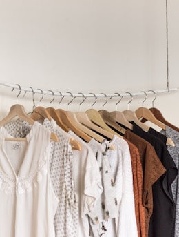 assorted clothes in wooden hangers