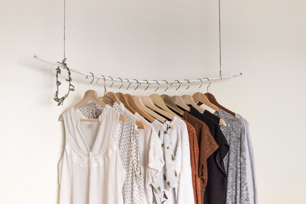 assorted clothes in wooden hangers