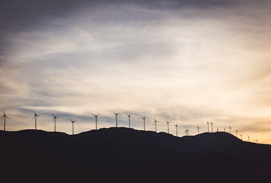 silhouette photo of wind turbines on hill in Kalavrita Greece