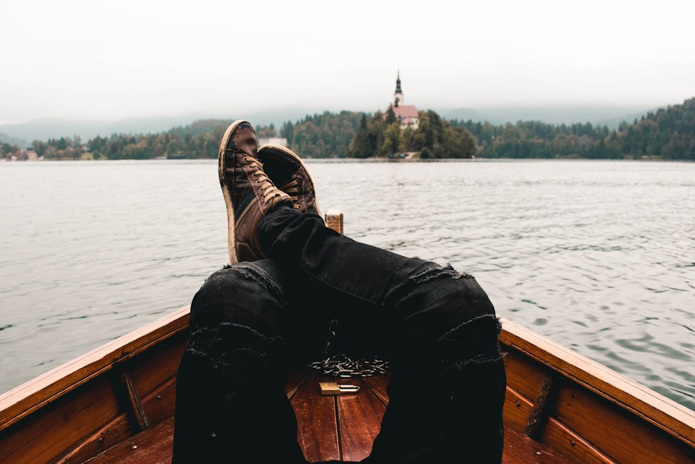 person wearing distressed black jeans on boat