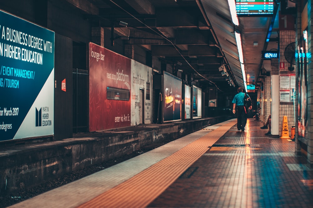 A lone man walking across the railway platform in Brisbane