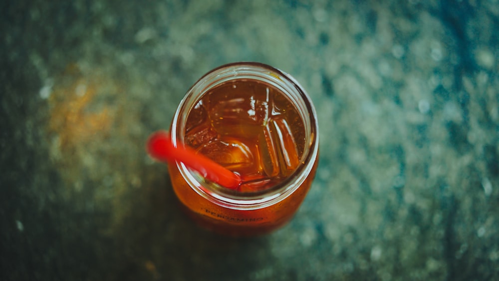 clear glass jar with red straw