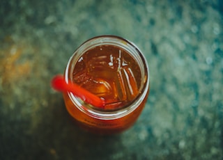 clear glass jar with red straw
