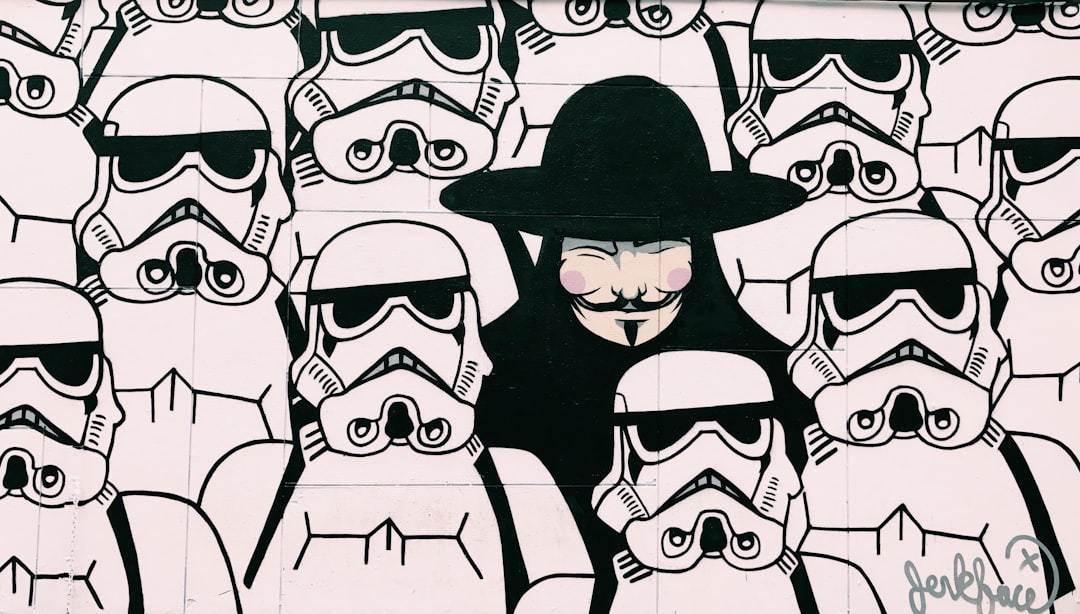 Anonymous Guy Fawkes from V from Vendetta figure amongst group of Star Wars stormtroopers in New York, Texas, United States