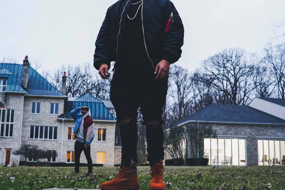 person standing on grass field during daytime