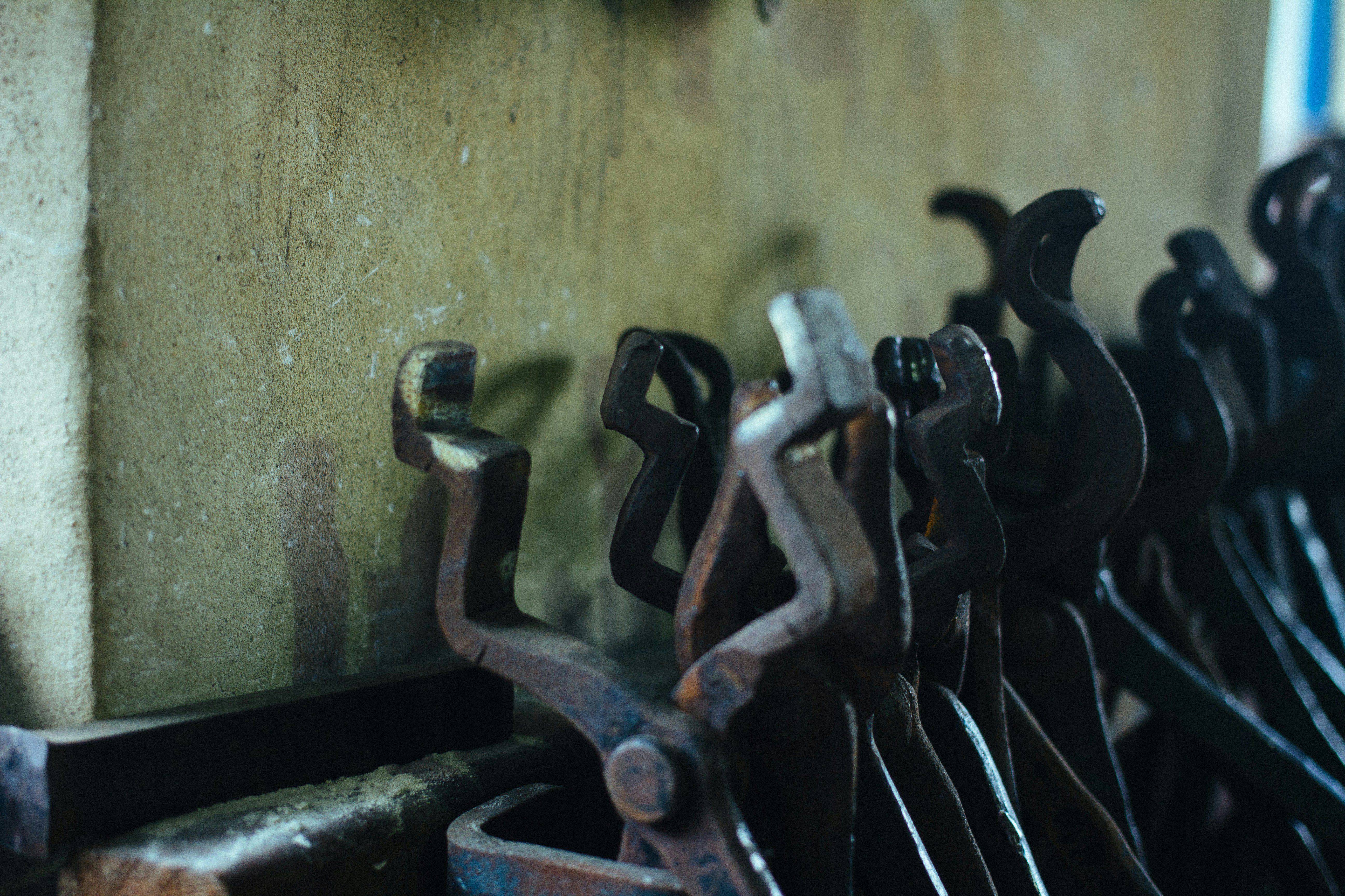 Set of metal hooks arranged neatly on a wooden wall in a boutique shop.