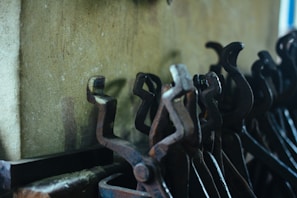 Set of wooden hooks arranged neatly on a rustic wall