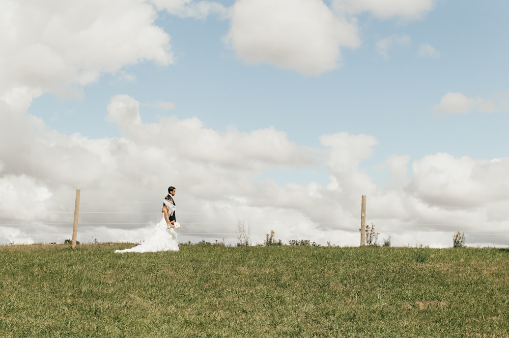 couple walking on green grass