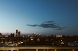 City skyline with illuminated buildings at dusk.