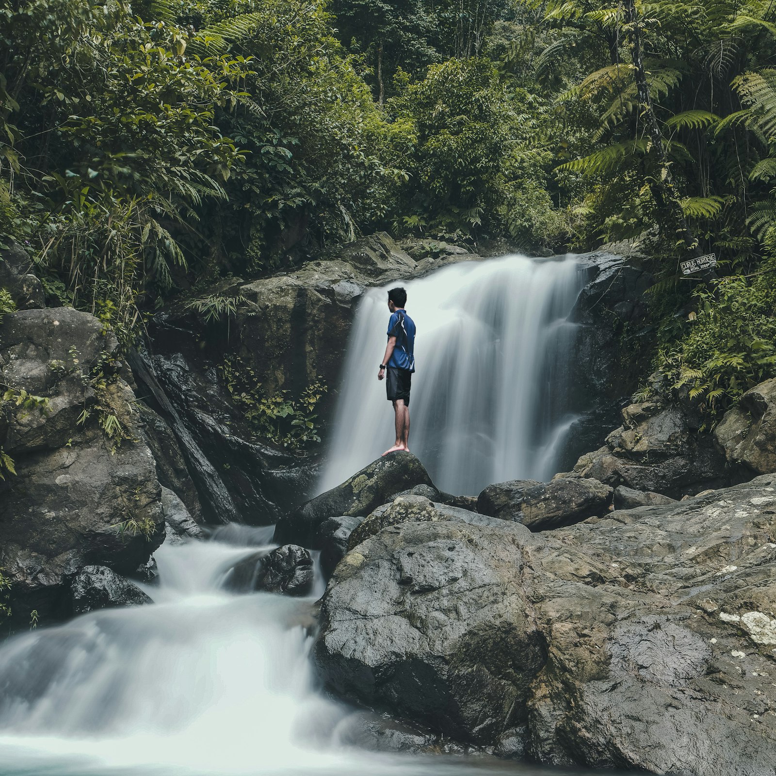 Samsung NX 16-50mm F3.5-5.6 Power Zoom ED OIS sample photo. Man standing on rocks photography