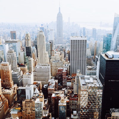 birds-eye view photo of city buildings with fog