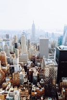 birds-eye view photo of city buildings with fog