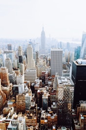 birds-eye view photo of city buildings with fog
