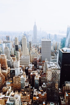 birds-eye view photo of city buildings with fog