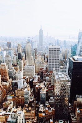 birds-eye view photo of city buildings with fog