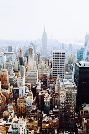 birds-eye view photo of city buildings with fog