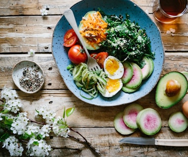 poached egg with vegetables and tomatoes on blue plate