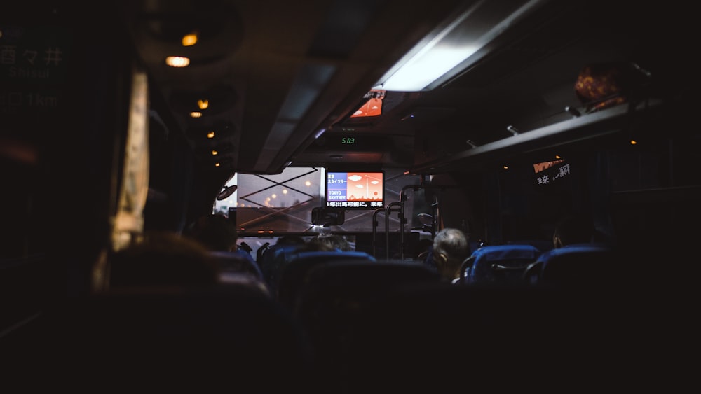 The dim interior of a coach driving through Tokyo