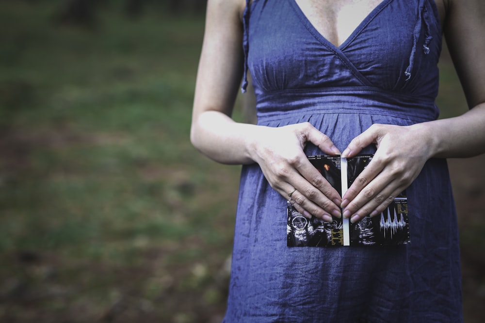 pregnant woman holding her tummy