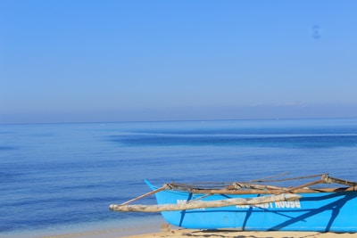 A serene image of a traditional Hawaiian canoe gliding over clear turquoise waters.