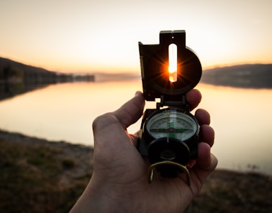 person showing black and white compass