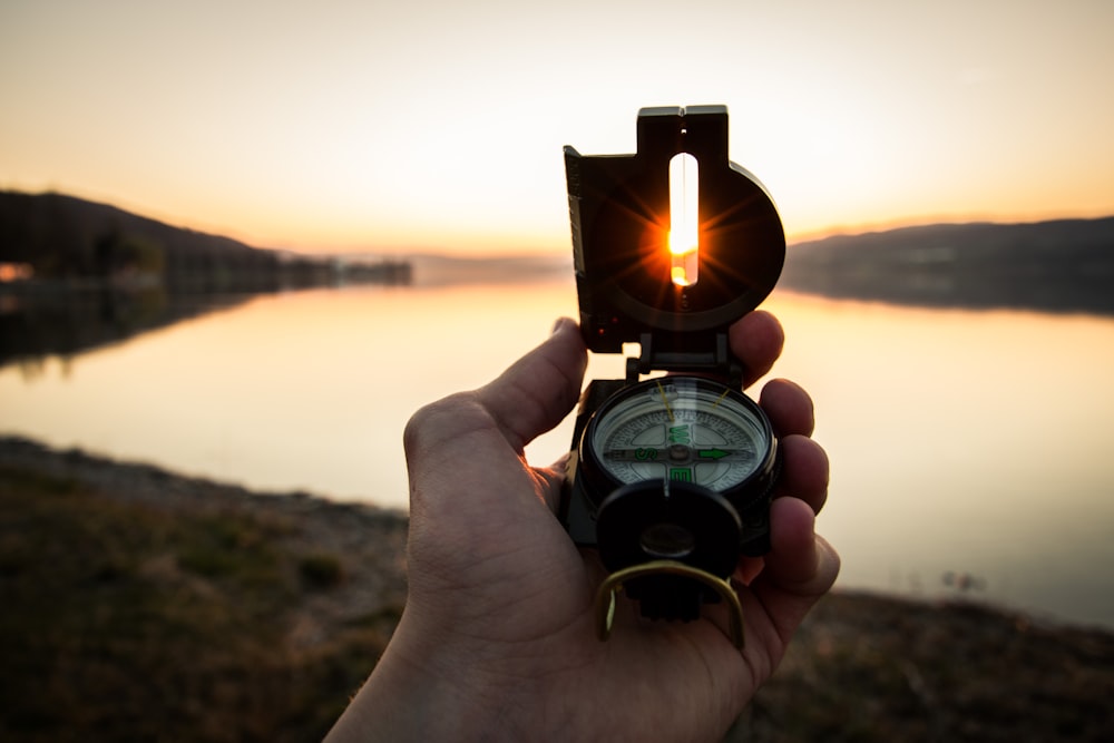 person showing black and white compass