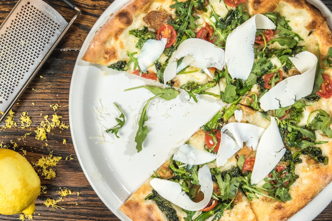 several sliced of vegetable pizza on round white platter, Pizza for High-End Italian Restaurant