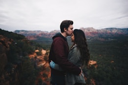 man kissing woman's forehead