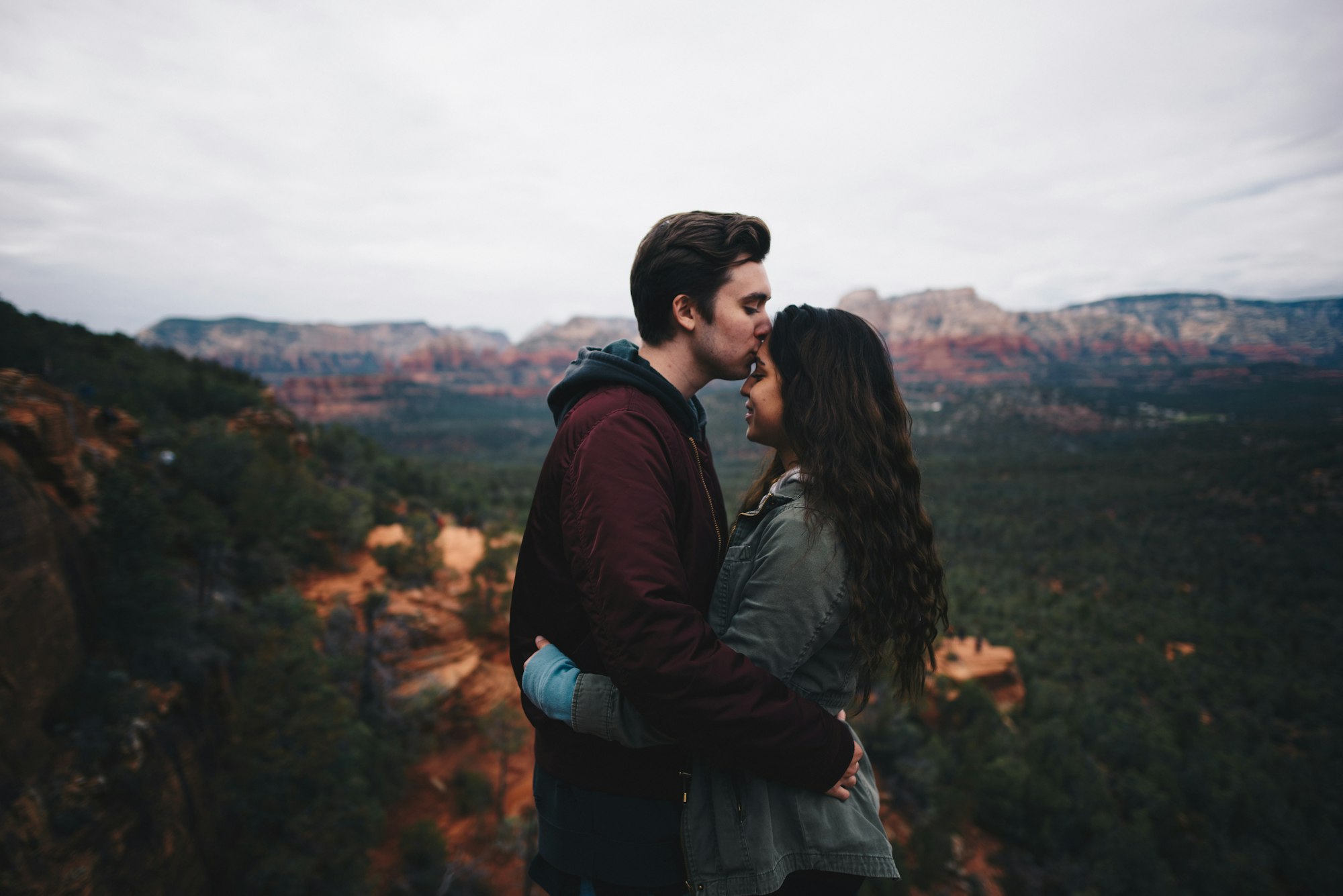 couple hugging in front of beautiful landscape