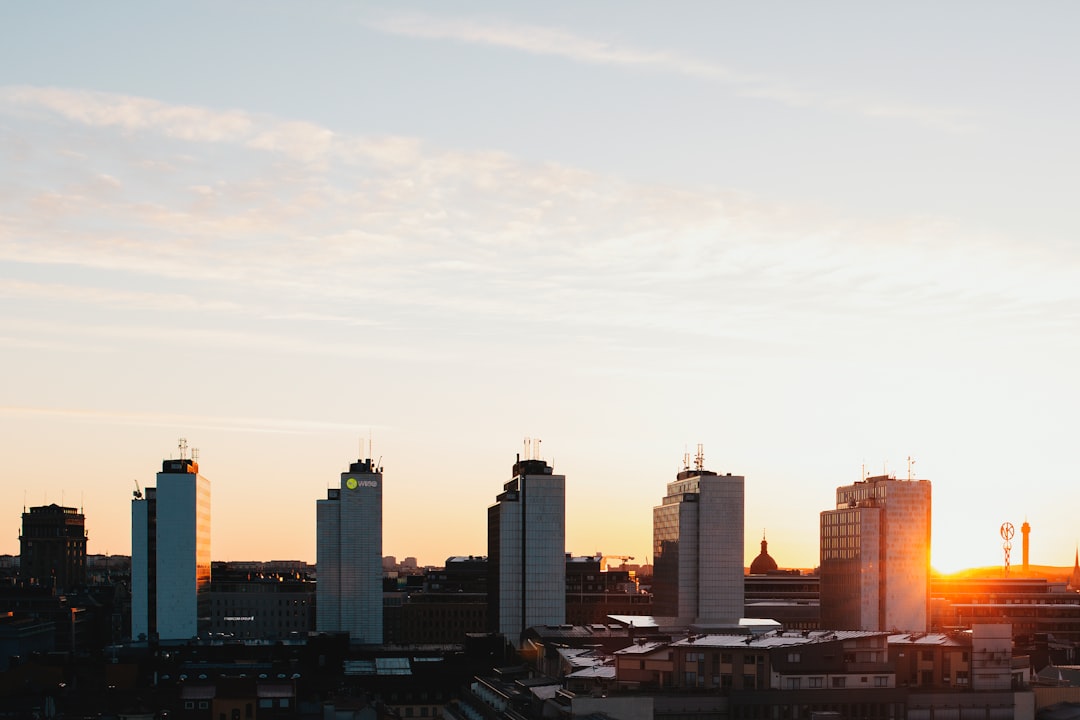 five white high-rise buildings under gray sky