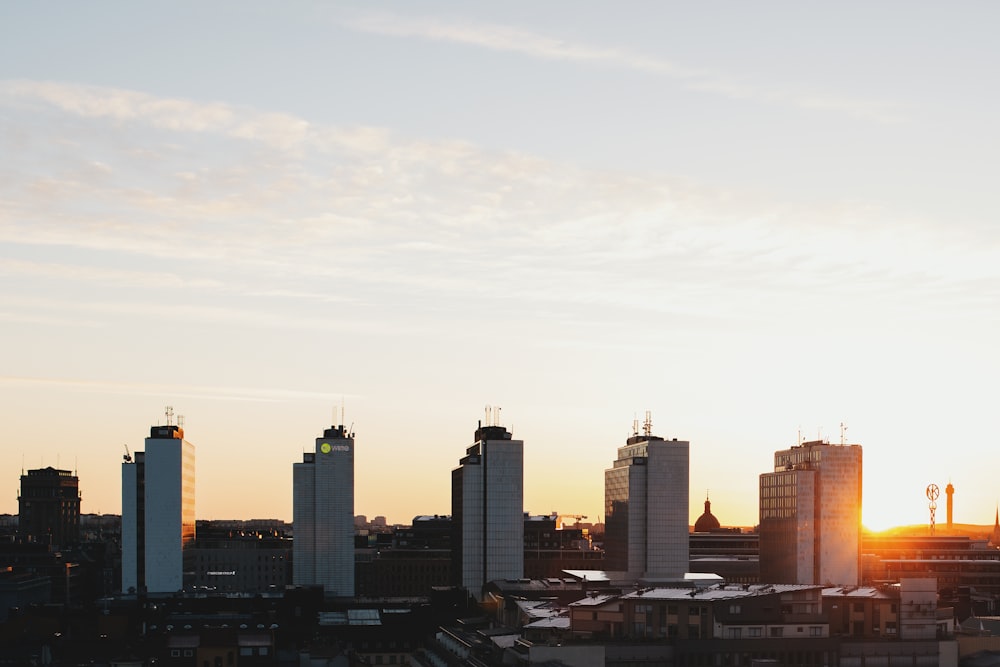 five white high-rise buildings under gray sky