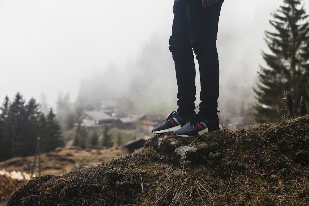 person standing on rock outdoor during daytime