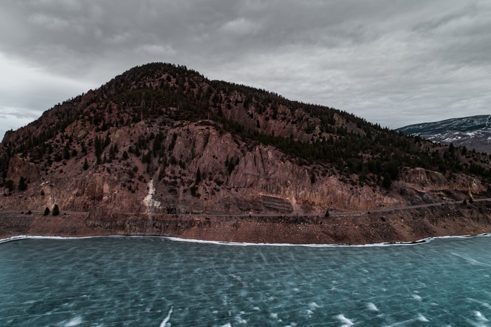 body of water beside mountain