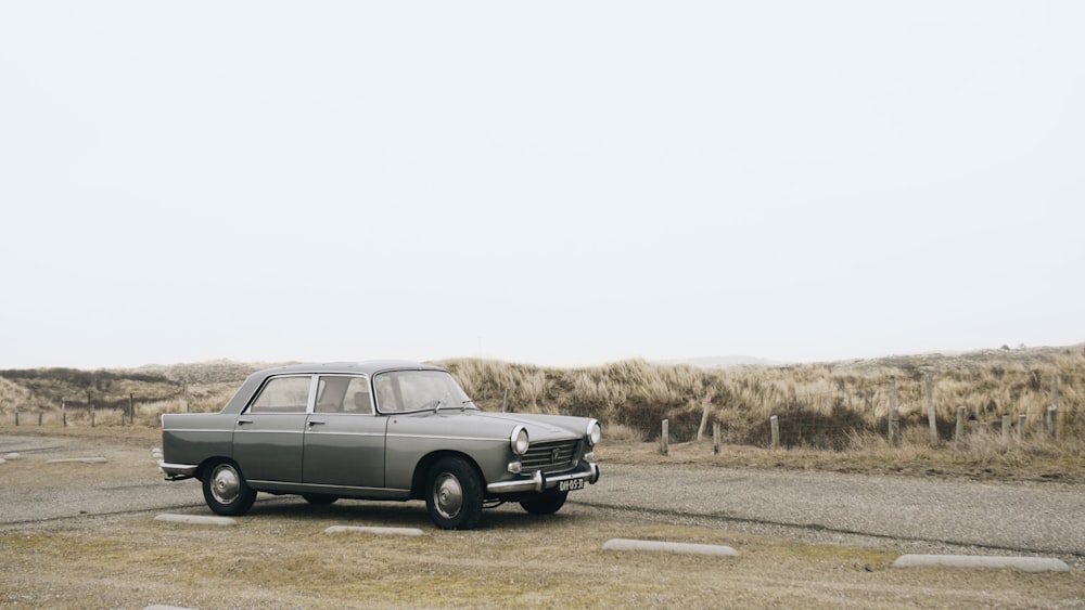 gray sedan parked on roadside during daytime