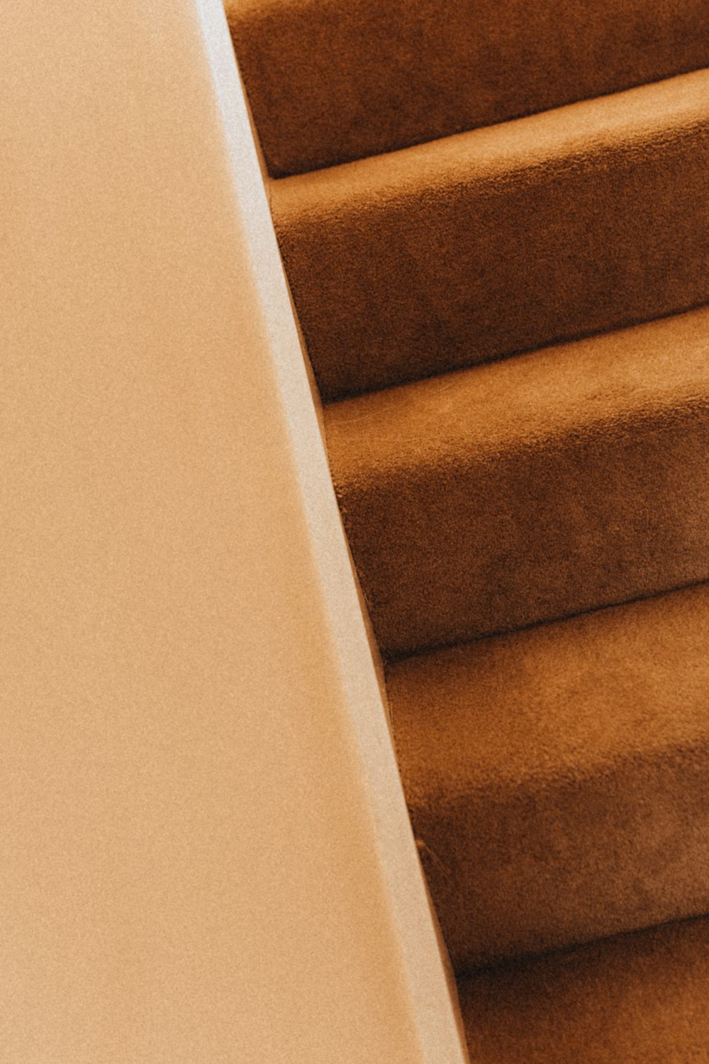 brown staircase with white wall