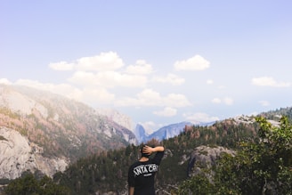 man standing near mountain under clear syk
