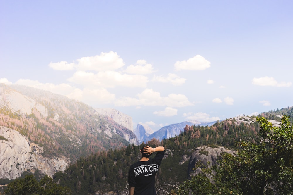 man standing near mountain under clear syk