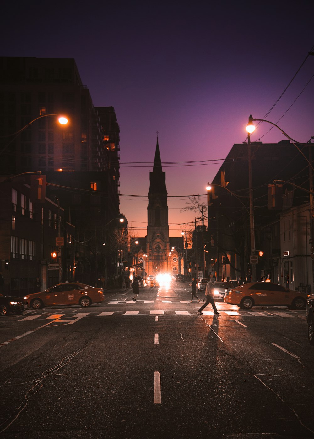 People crossing the street at night.