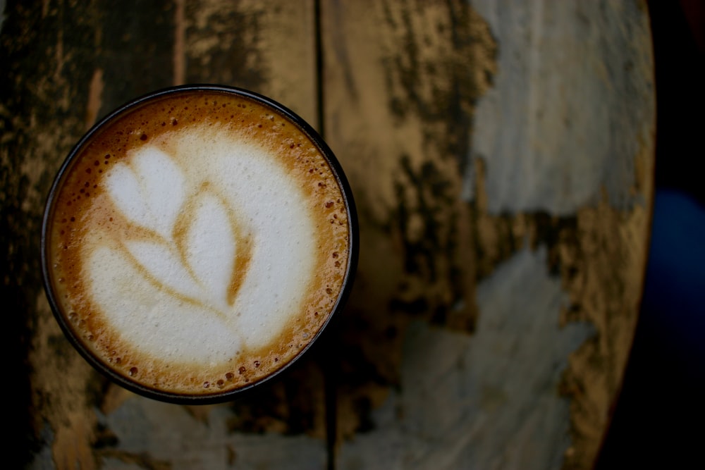 black mug filled with latte