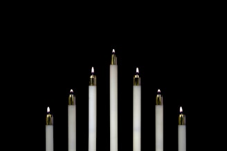 seven white candles closeup photography