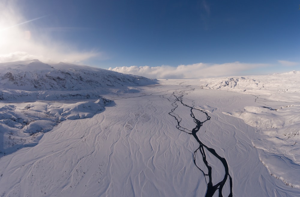 landscape photo of snowy mountains under cloudy sky during daytime