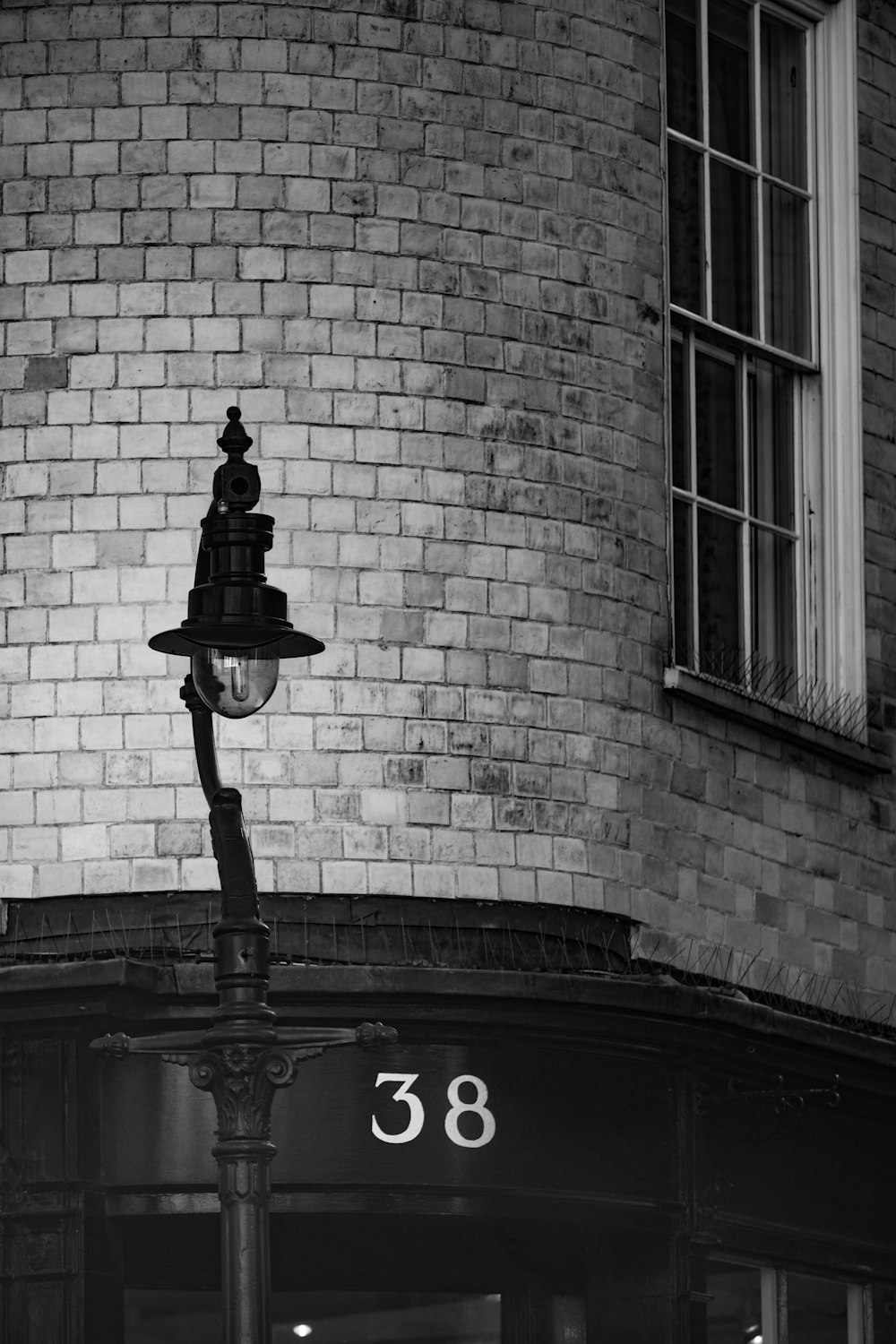 grayscale photo of metal light street post