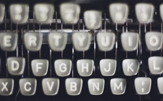 Close-up of typewriter keys with a soft-focus background.