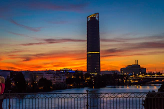 A modern apartment building overlooking the Nile River at sunset.