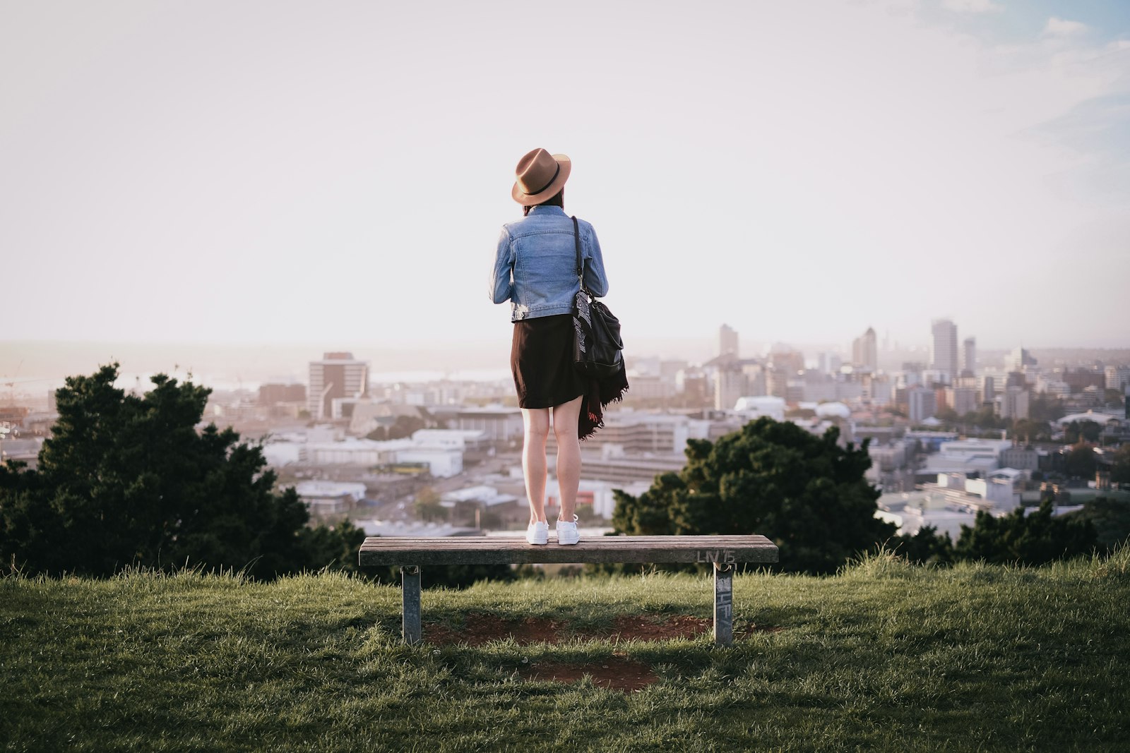 Fujifilm X-T1 + Fujifilm XF 35mm F1.4 R sample photo. Woman standing on bench photography