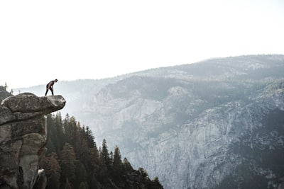 man standing on cliff adventurous teams background