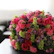 A vibrant bouquet of roses being delivered at a cozy home doorstep.