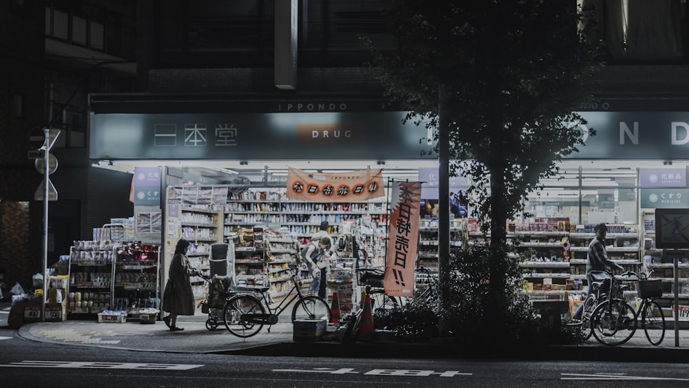 photo of man and woman standing near bicycles and opened establishment