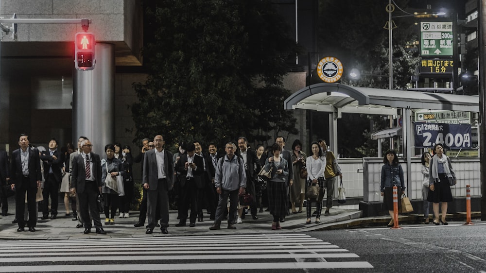 people standing in front of pedestrian lane during daytime