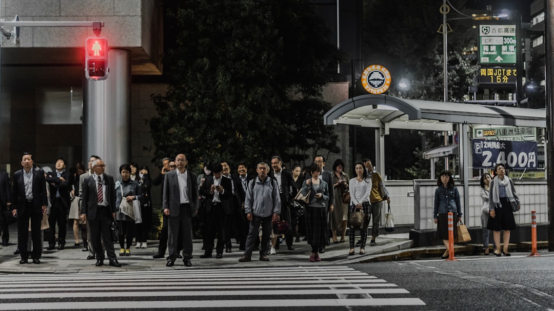 people standing in front of pedestrian lane during daytime